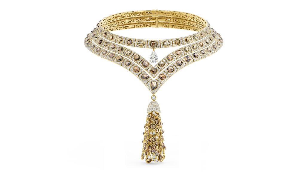 This tassel necklace features pavé-set white diamonds surrounding rough brown diamonds. Three separate necklaces come together to create this look, with a 3.33-carat pear-shaped white diamond on the uppermost tier, along with a tassel of rough brown diamonds and round brilliant white diamonds on the lower tier. De Beers high jewelry Dignity Tassel Necklace